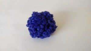 a finished purple pom pom