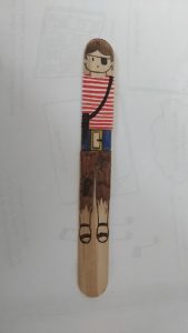 A pirate drawn onto a popsicle stick.