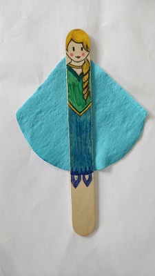 A popsicle stick drawn to look like Queen Elsa, with a small blue fabric cape.