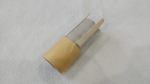 Toilet paper tube with popsicle sticks and yellow paper wrapped around the bottom half
